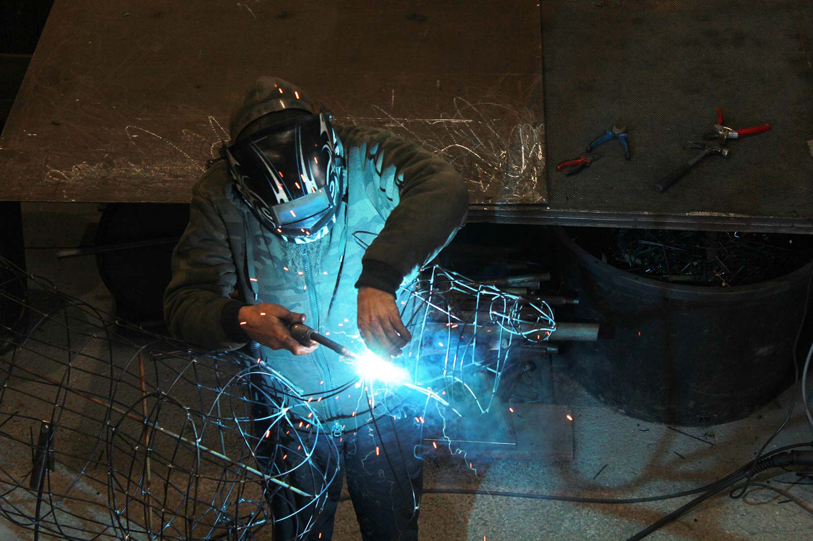 Luigi welding a topiary armature