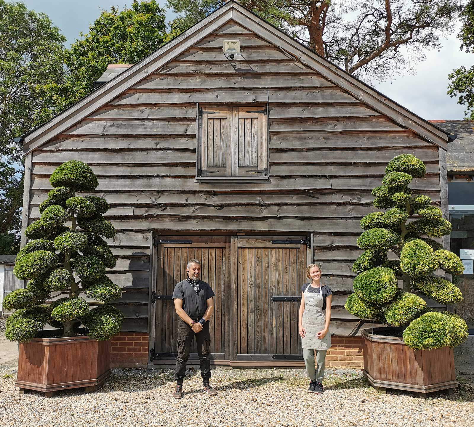 Rachel and Luigi stood outside te topiary workshop